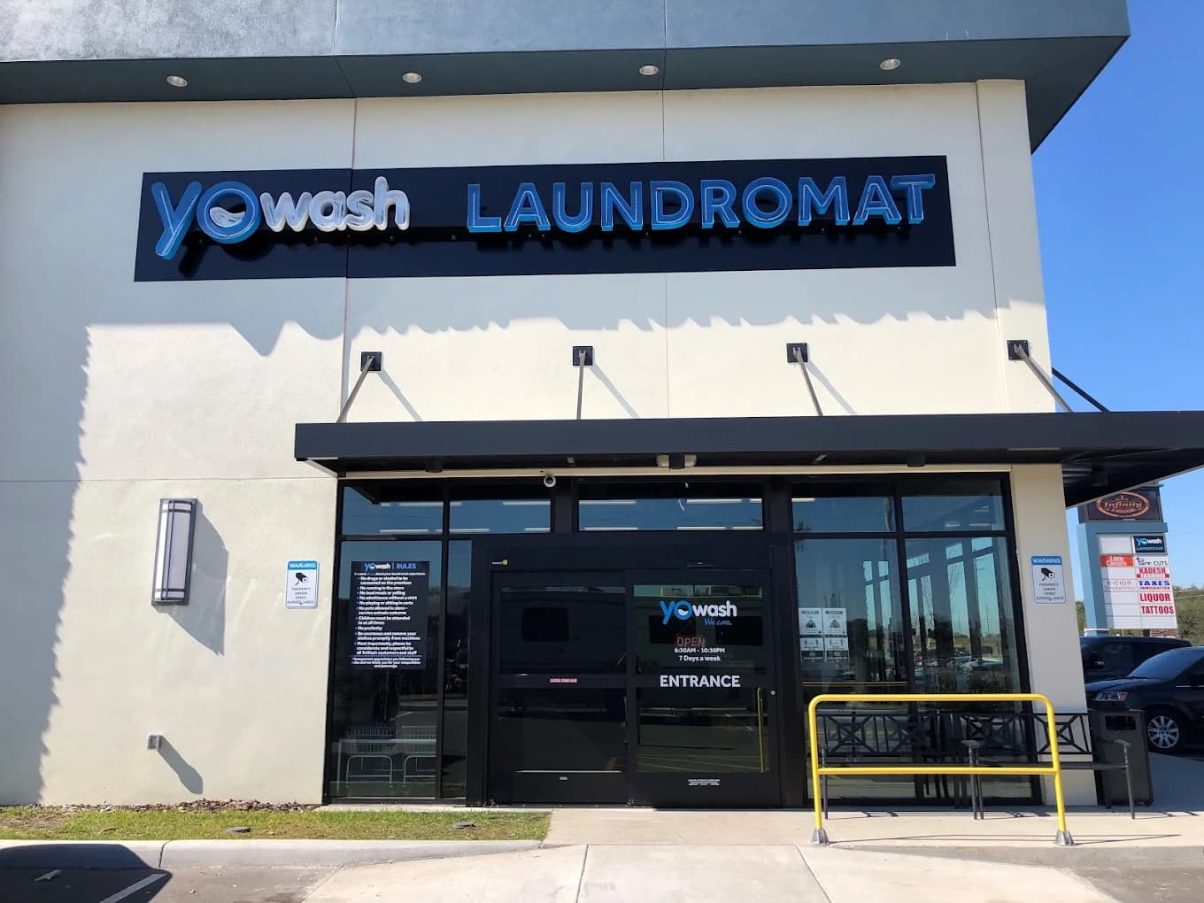 Inside YoWash Four Corners — rows of modern washers and dryers in a bright, clean interior