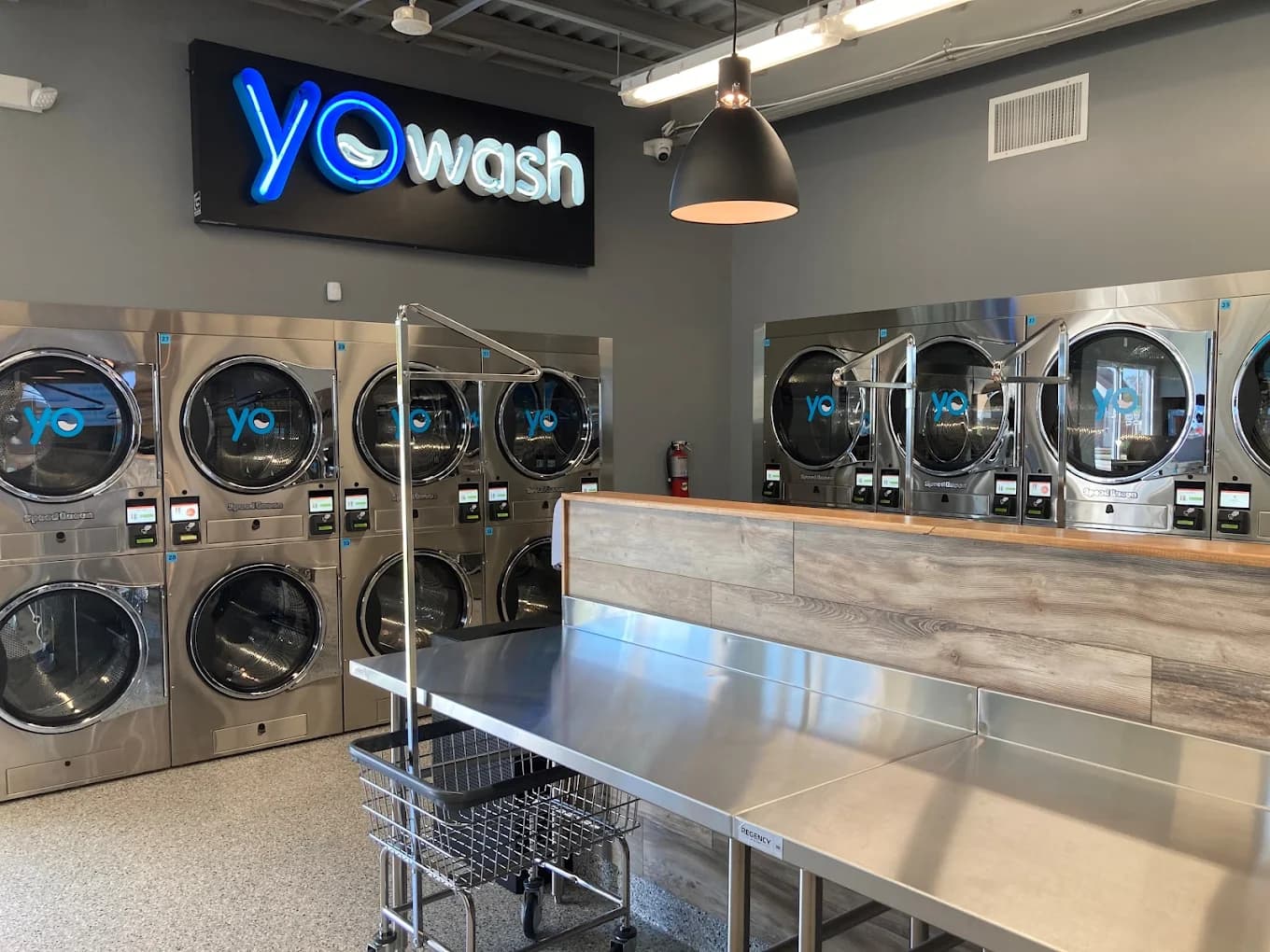 Inside YoWash Lakeland — rows of modern washers and dryers in a bright, clean interior