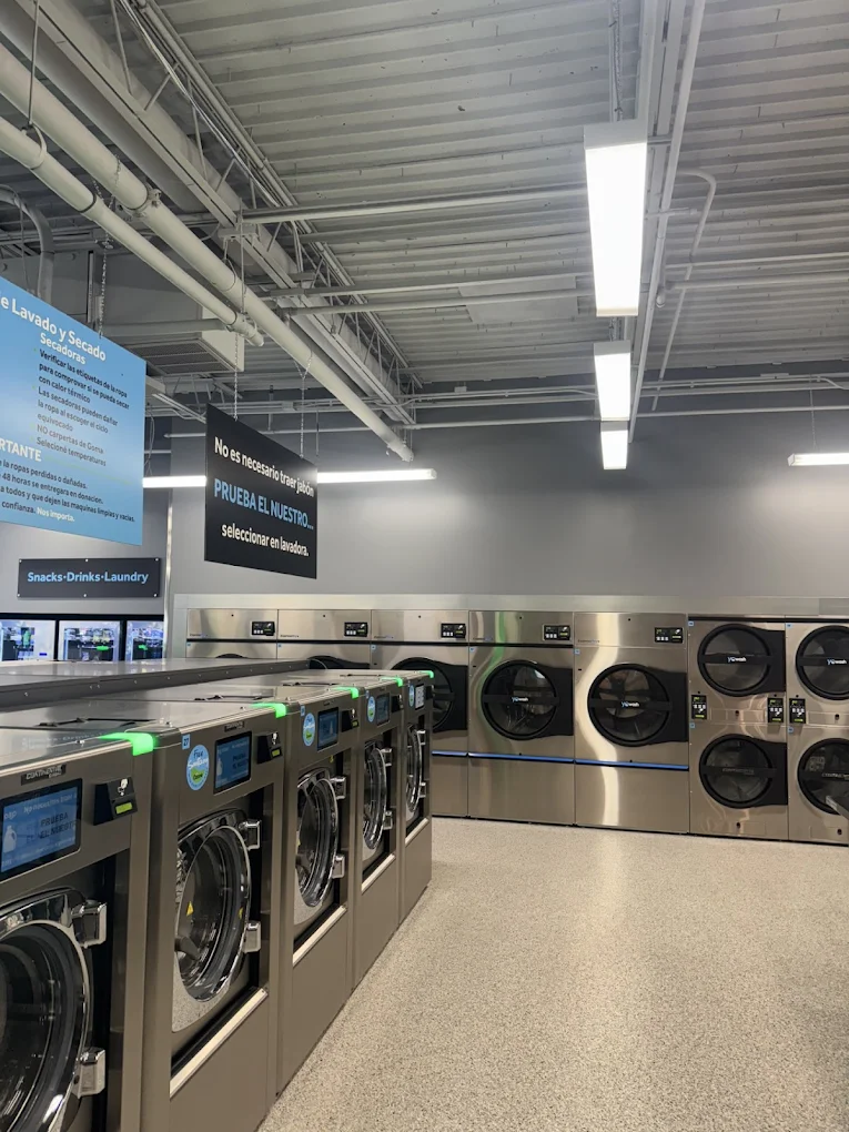 Inside YoWash Bradenton East — modern Girbau washers and dryers in a bright, clean interior