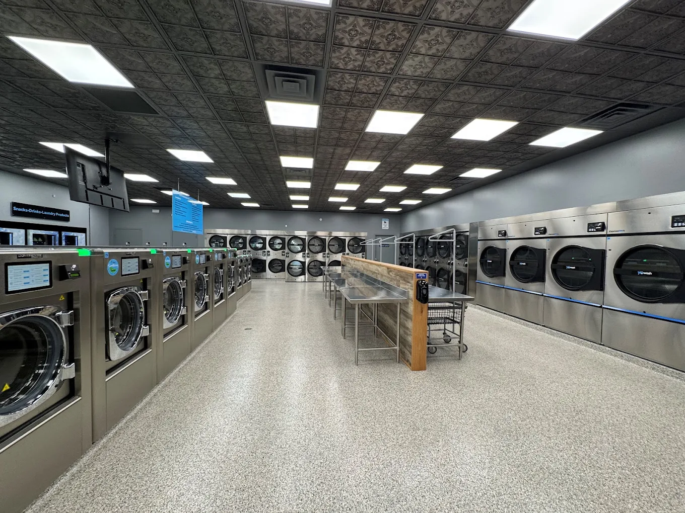 Inside YoWash Sarasota — modern washers and dryers in a bright, clean interior
